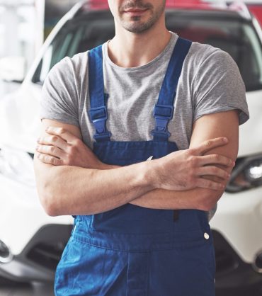 Hand of car mechanic with wrench. Auto repair garage.