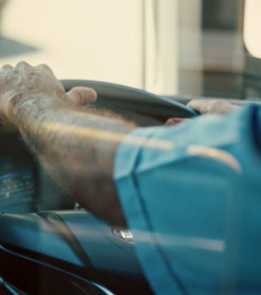 Hands, wheel and person for driving bus for public transportation, local service and urban travel. .