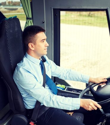 transport, tourism, road trip and people concept - happy driver driving intercity bus